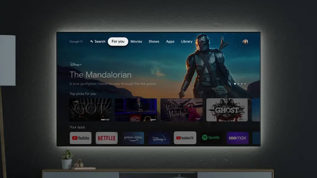 The Google TV interface on a TV screen in a darkened room